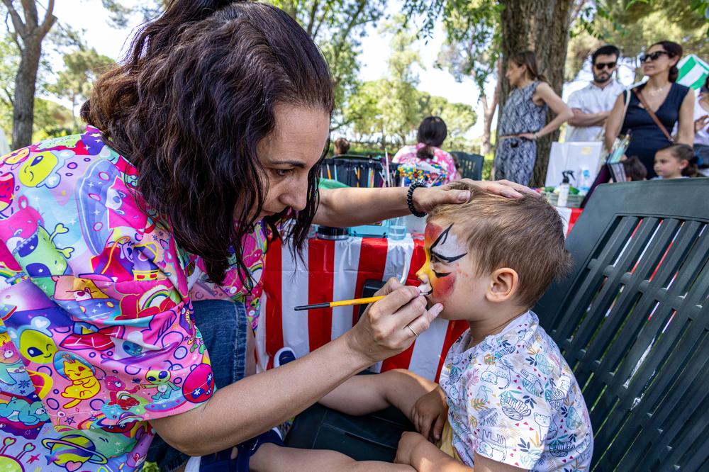 Momento en el que se le decora la cara a un niño en el área de pintacaras.